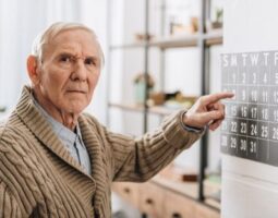 old man touching calendar